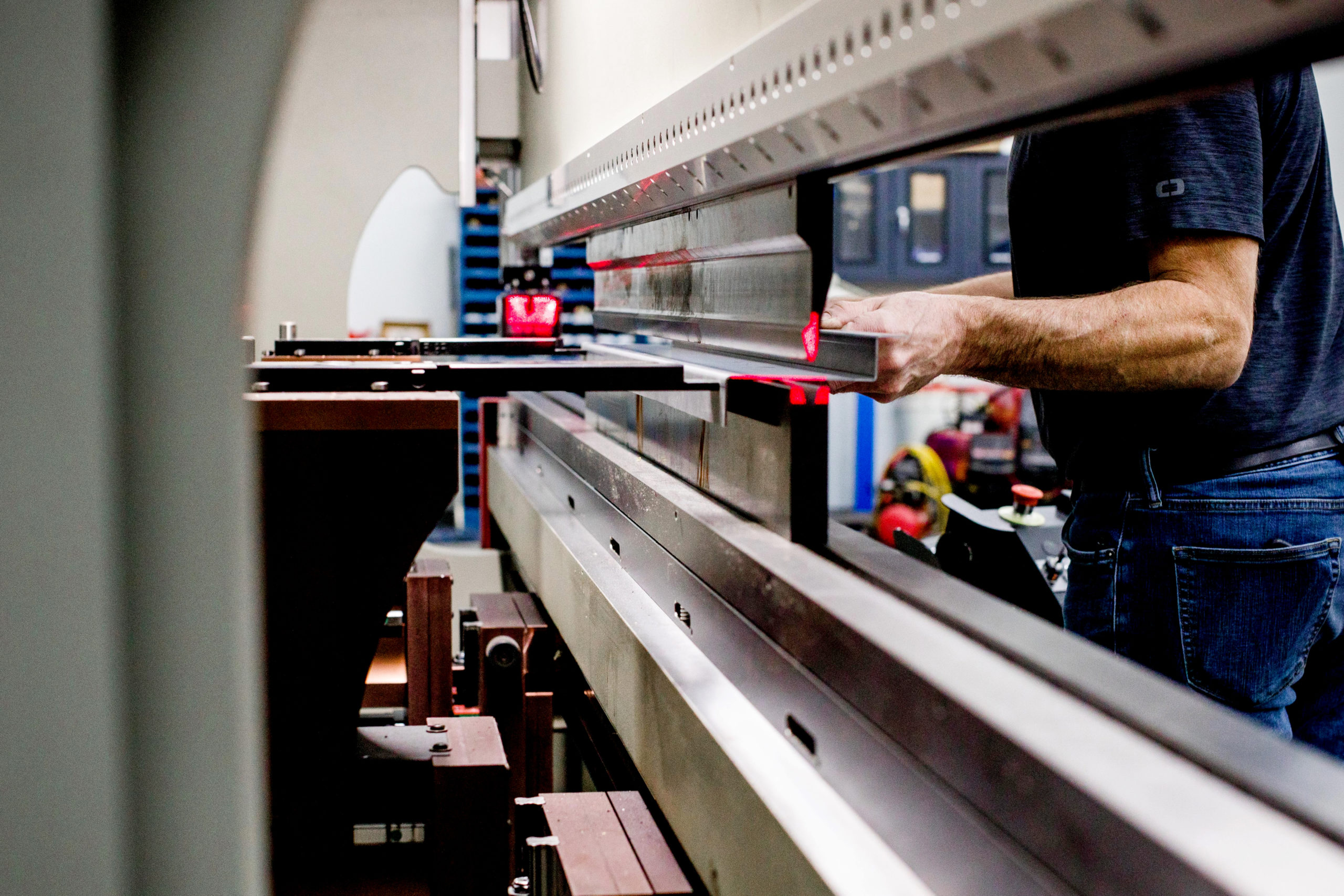 JKS Incorporated's director of fabrication, Michael Tennyson, uses the press brake to form a piece of steel.