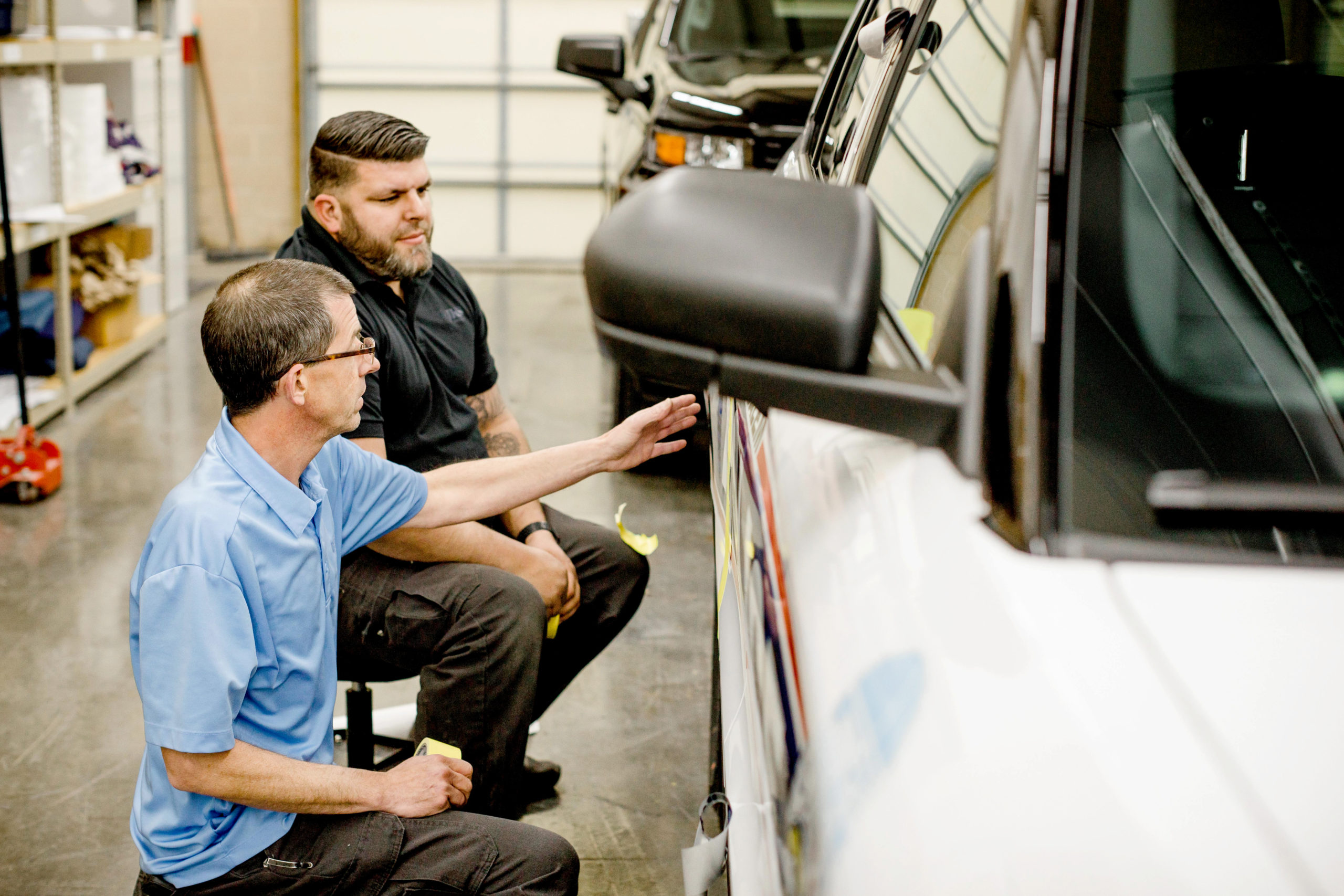 Shane and Jordan discuss the details of a vehicle graphics installation project.